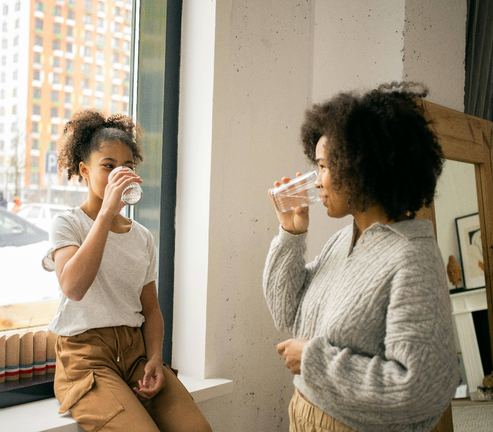 happy-woman-and-girl-drinking-probiotic-supplement