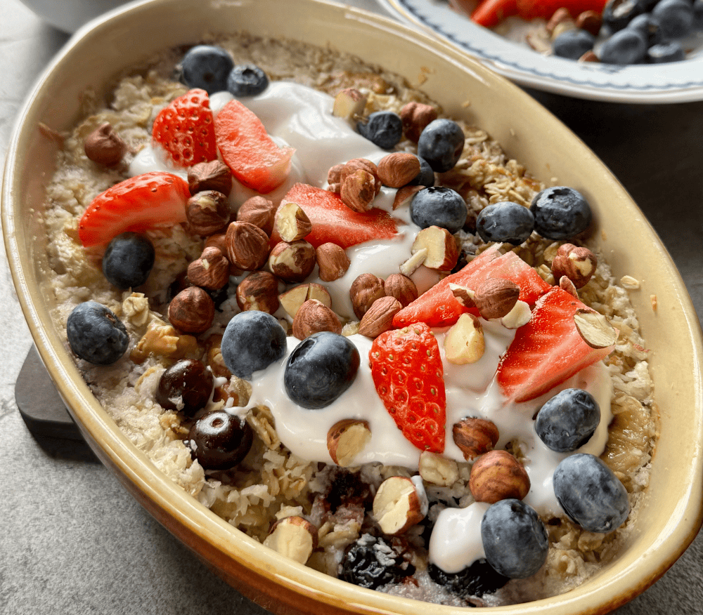 A dish of slow-cooked oats topped with berries and nuts