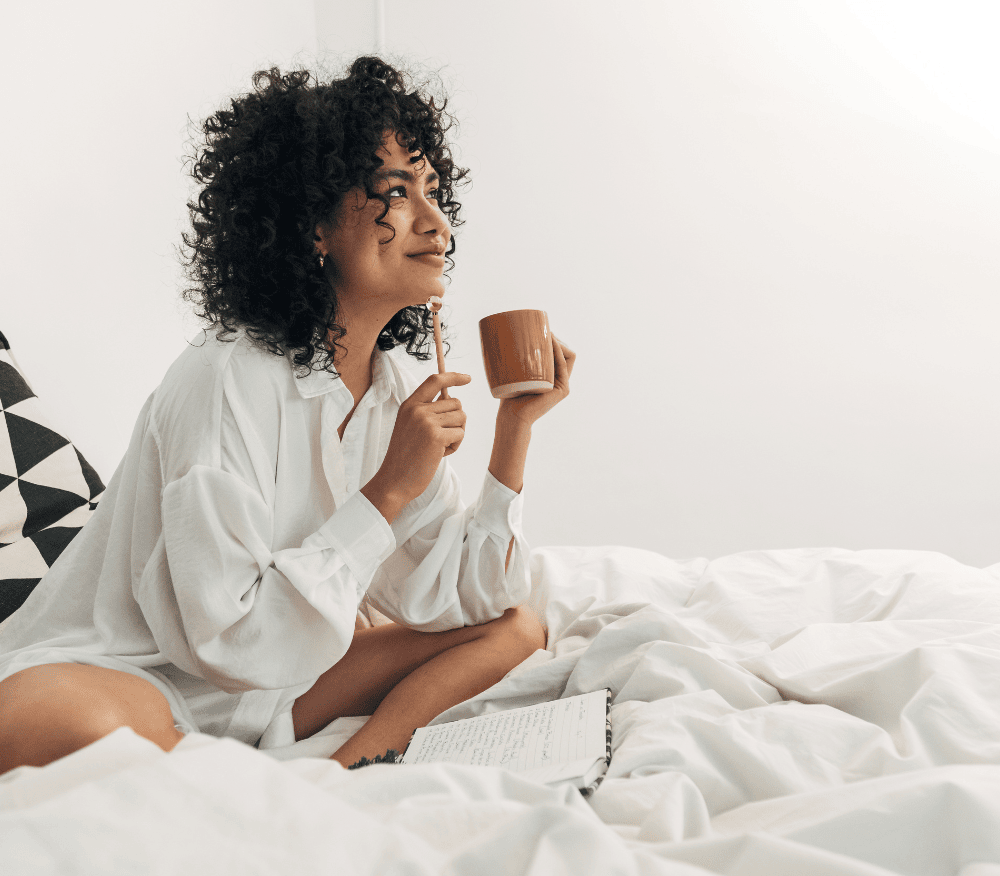 woman journaling while sitting in bed